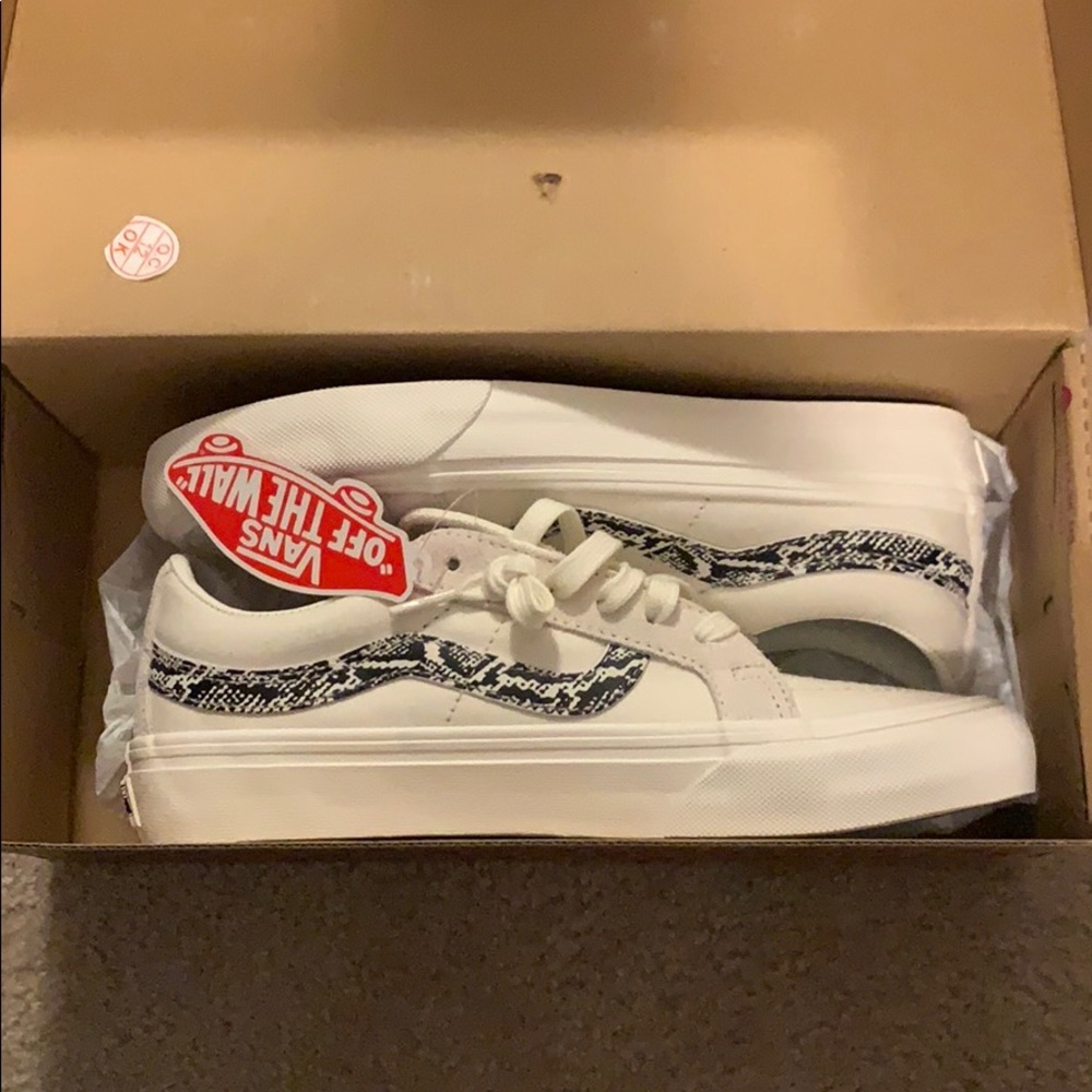 White and snake print Vans. Never worn.